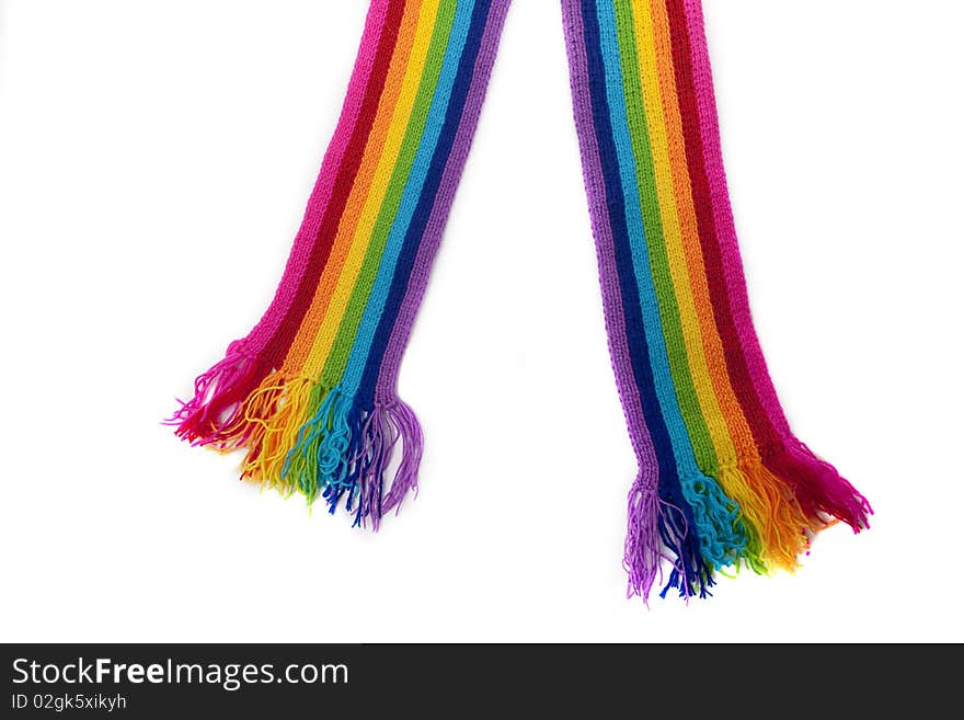 The image of a bright rainbow knitted scarf