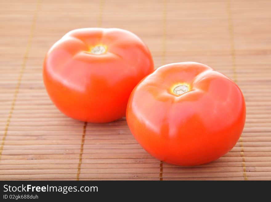 Red tomatoes obove bamboo napkin