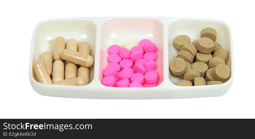 Capsules and pills on white background