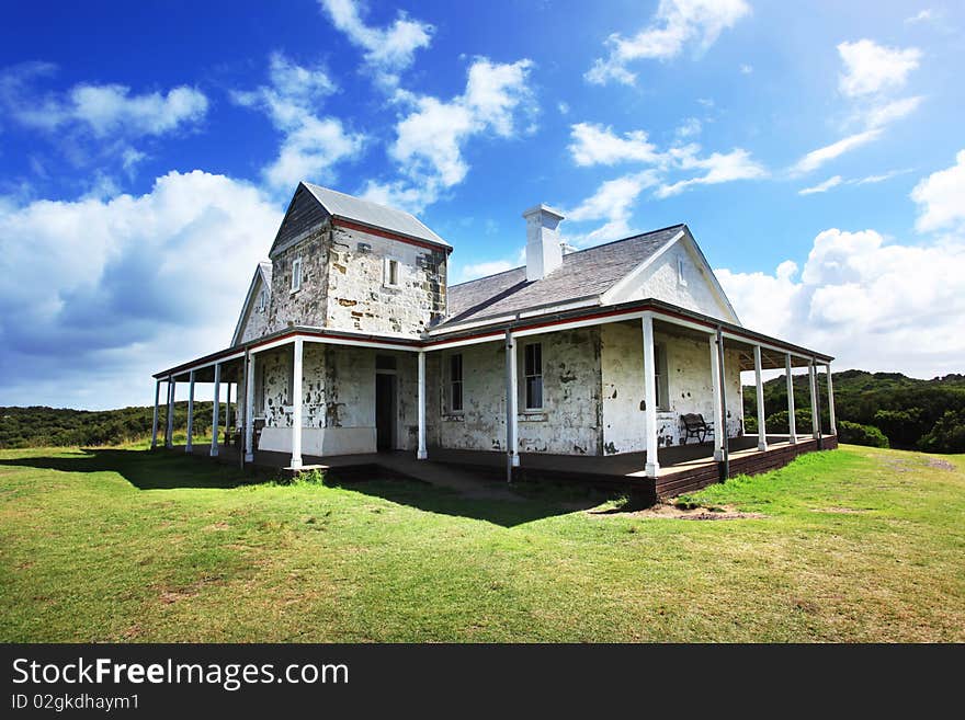 A small house with blue sky and clouds, shot in Cape Otway,Australia. A small house with blue sky and clouds, shot in Cape Otway,Australia