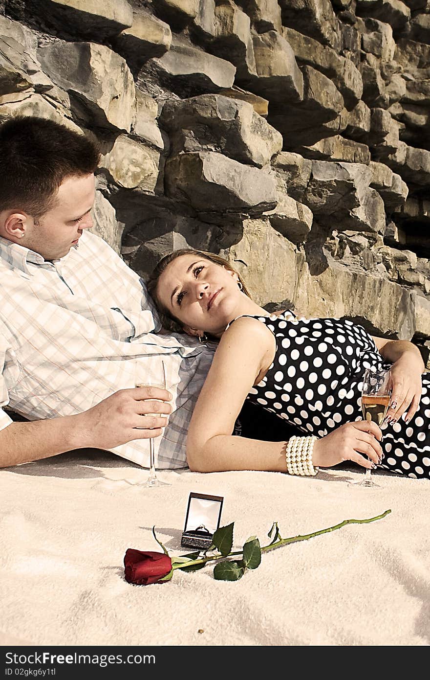 Engaged couple enjoing sunny day on the beach