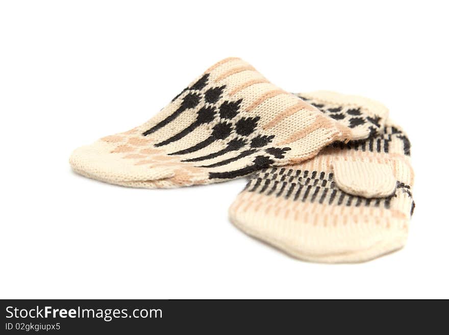 Beige mittens with patterns on a white background