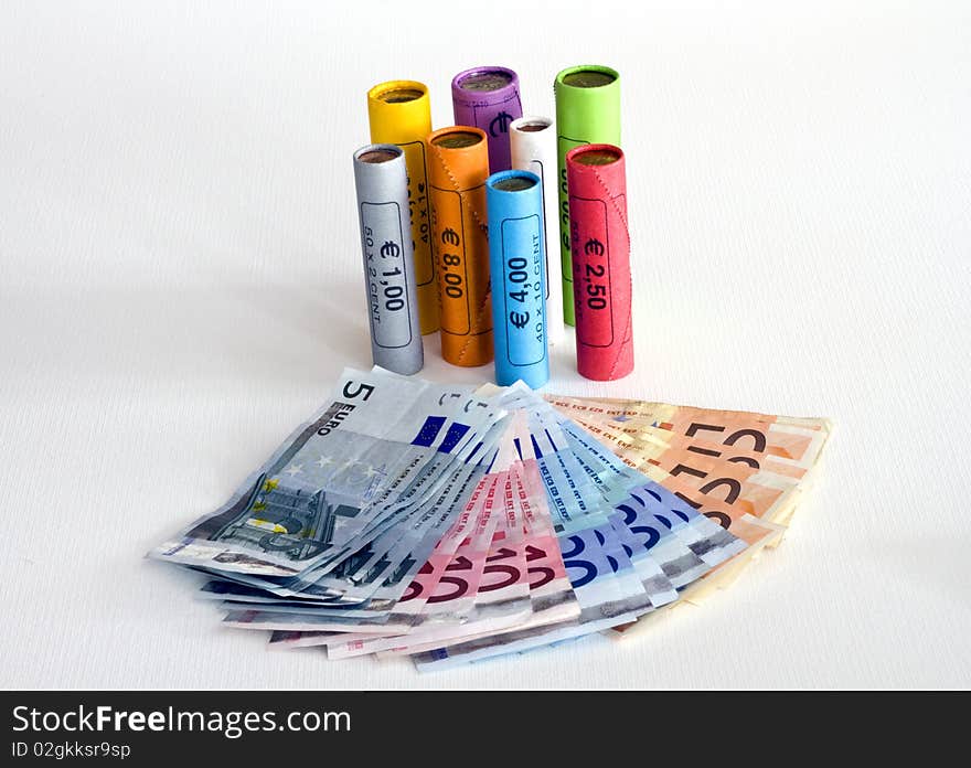 Euro notes and coins in colored packages. Euro notes and coins in colored packages