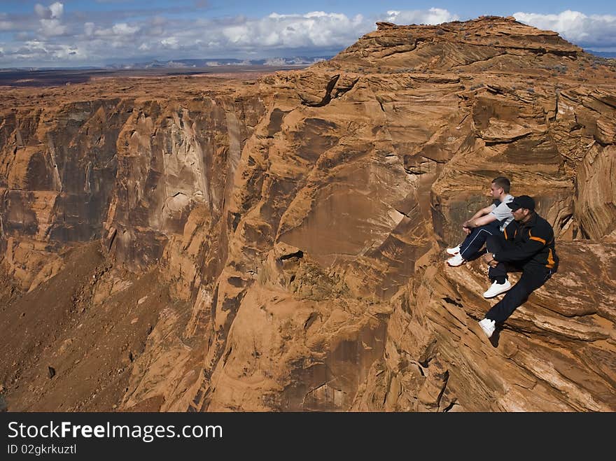 2 hikers resting at the top of a cliff in Arizona, USA. 2 hikers resting at the top of a cliff in Arizona, USA