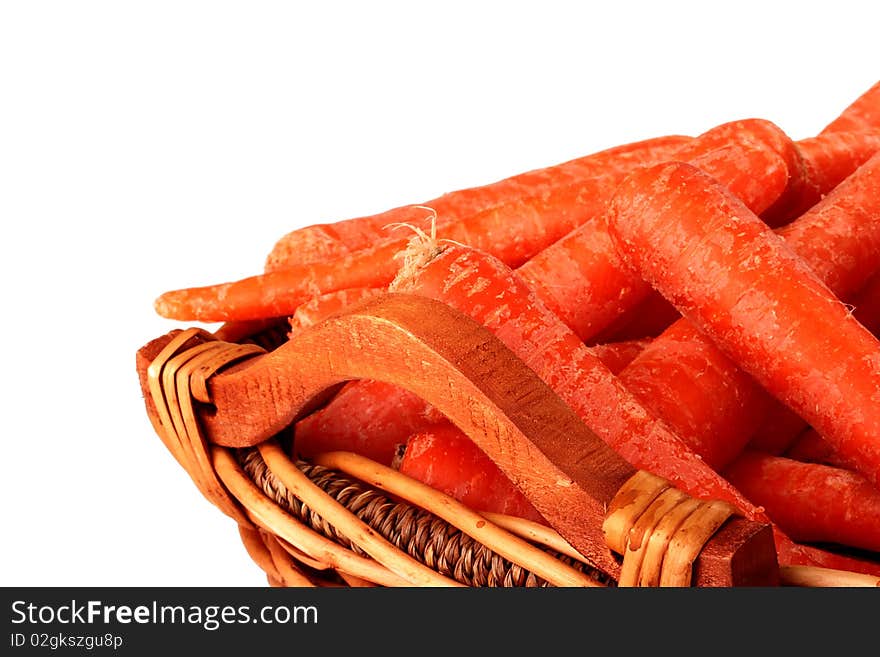 Carrot crop in a wattled basket on a white background.