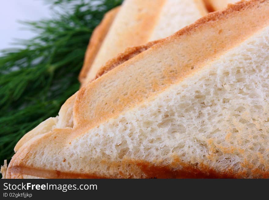 The close up of bread of which is made a sandwich in a roaster.