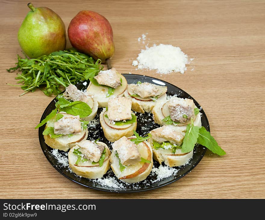 Quick and delicious appetizers, with prepared salmon, rucola and pear. Quick and delicious appetizers, with prepared salmon, rucola and pear