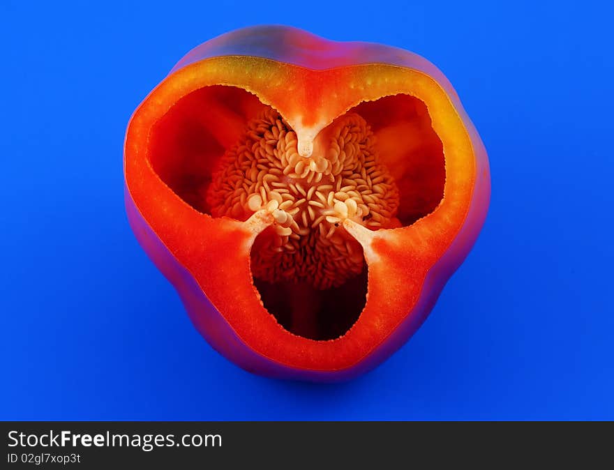 Sliced red pepper on a blue background