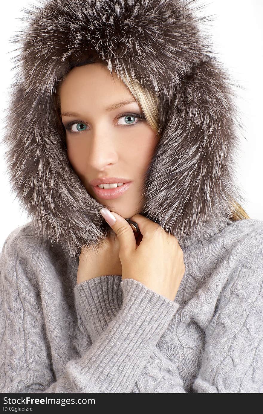 Portrait of a young and attractive blond with a winter hat. Image isolated on a white background.