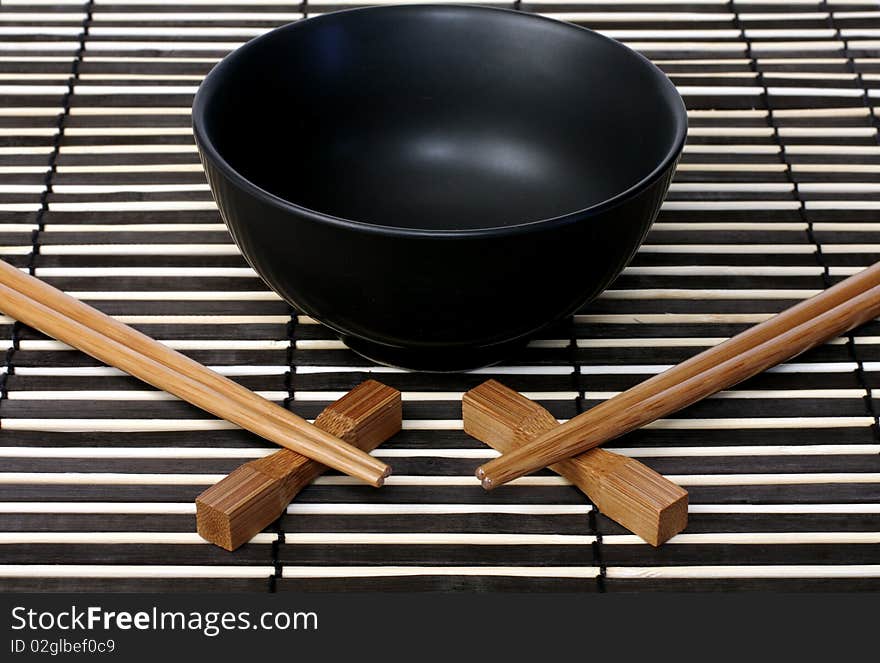 Black bowl and wooden chopsticks for sushi. Black bowl and wooden chopsticks for sushi