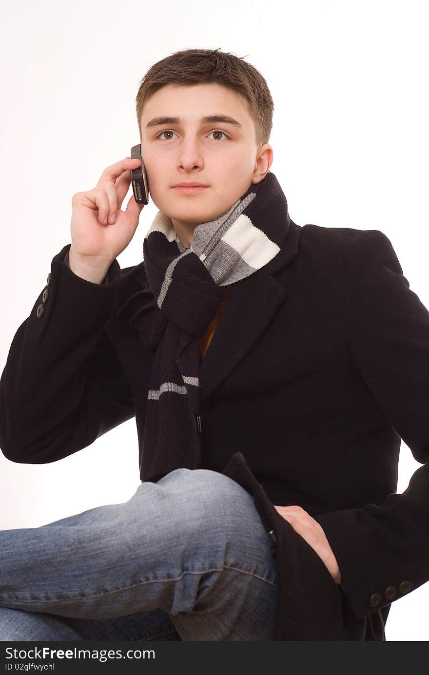 Handsome young man with a phone on a white background