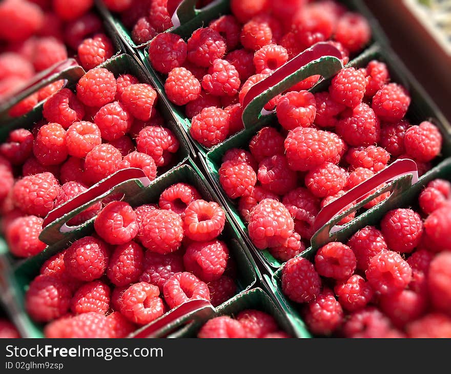 Raspberries in small cases on a french market