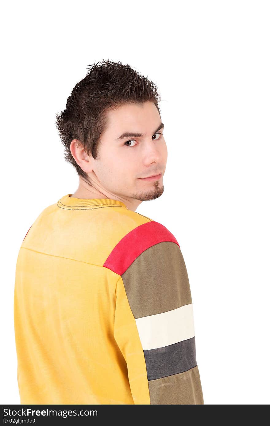 Rear view portrait of young man looking at camera, studio shot