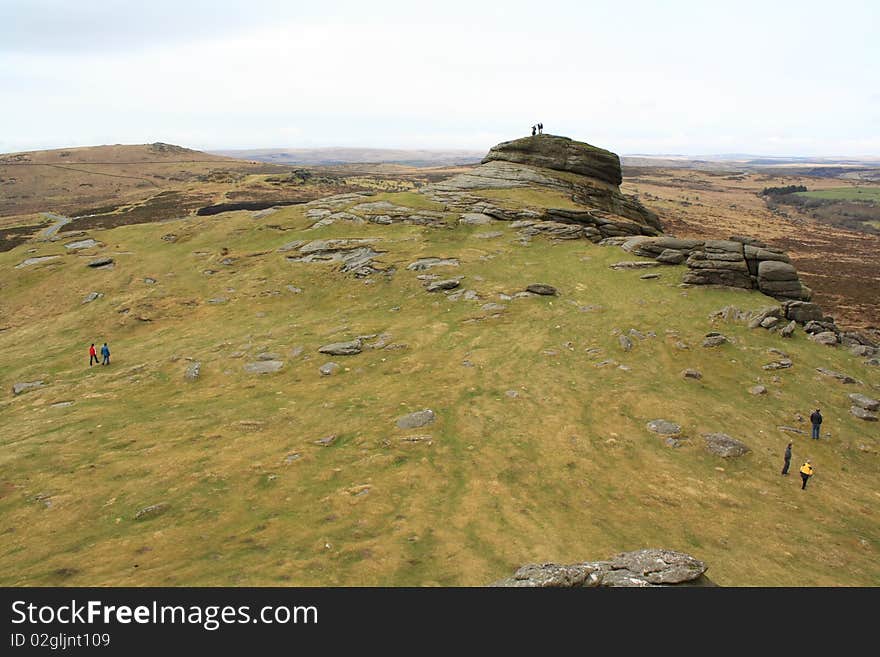 Group of people on the top of a rocky hill