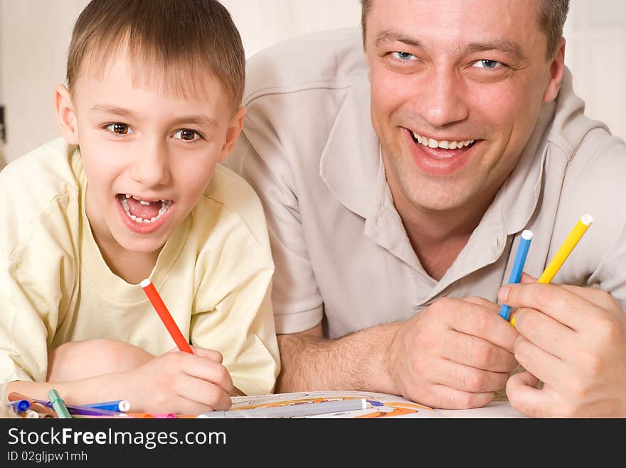 Father and son on the carpet and paint. Father and son on the carpet and paint