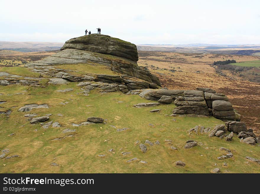 Group of people on the top of a rocky hill. Group of people on the top of a rocky hill