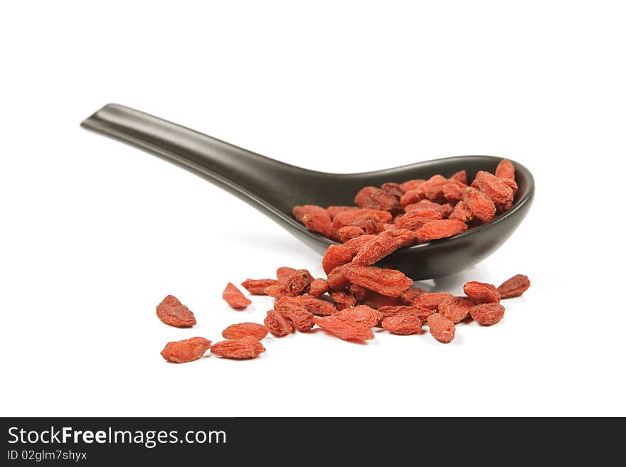 Goji Berries On A Black Spoon