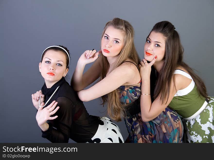 Three happy retro-styled girls in studio