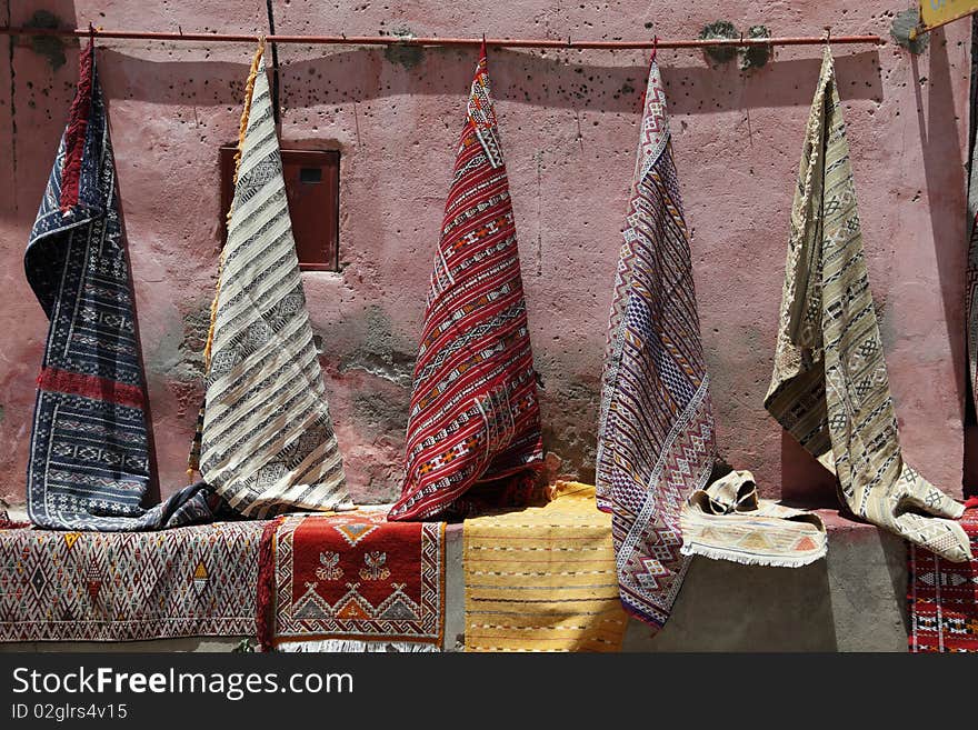 Moroccan rugs for sale as a market.