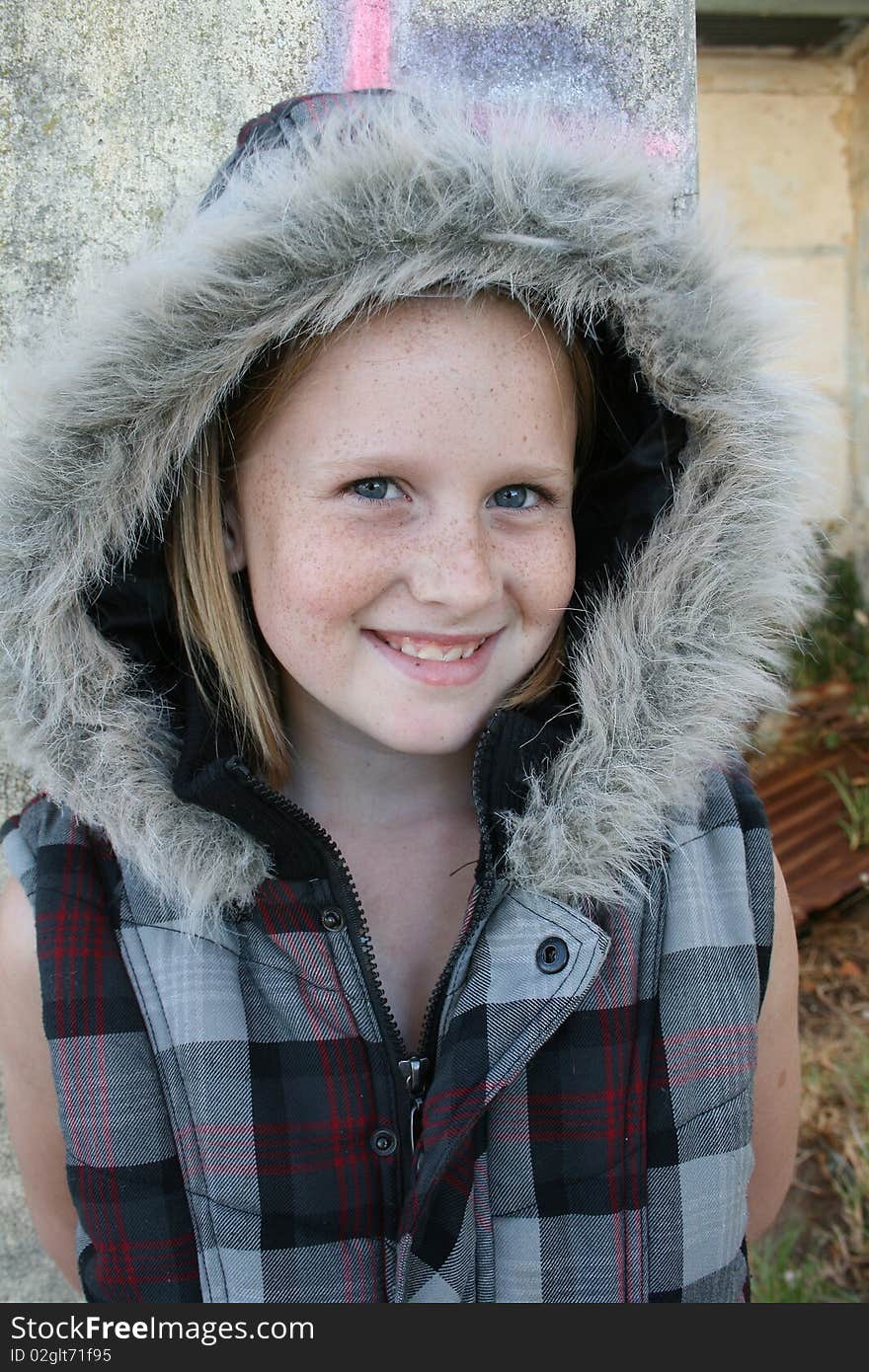 A cute white, caucasian girl child with a winter jacket. A cute white, caucasian girl child with a winter jacket