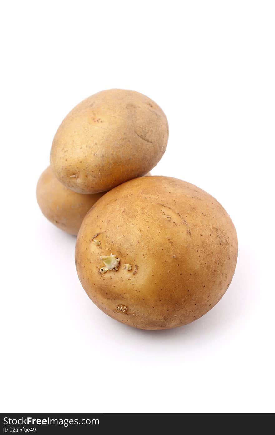 Three potatoes isolated on white background.