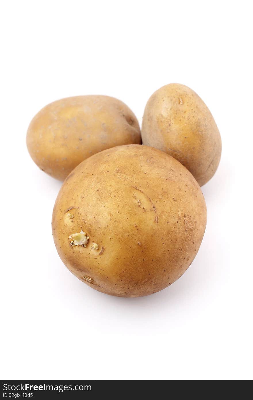 Three potatoes isolated on white background.