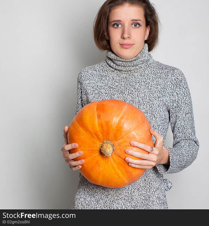 Young girl and pumpkin