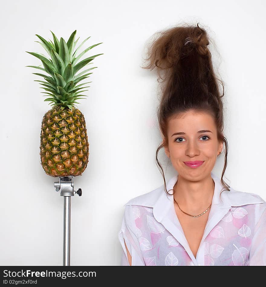 Young pretty girl and pineapple