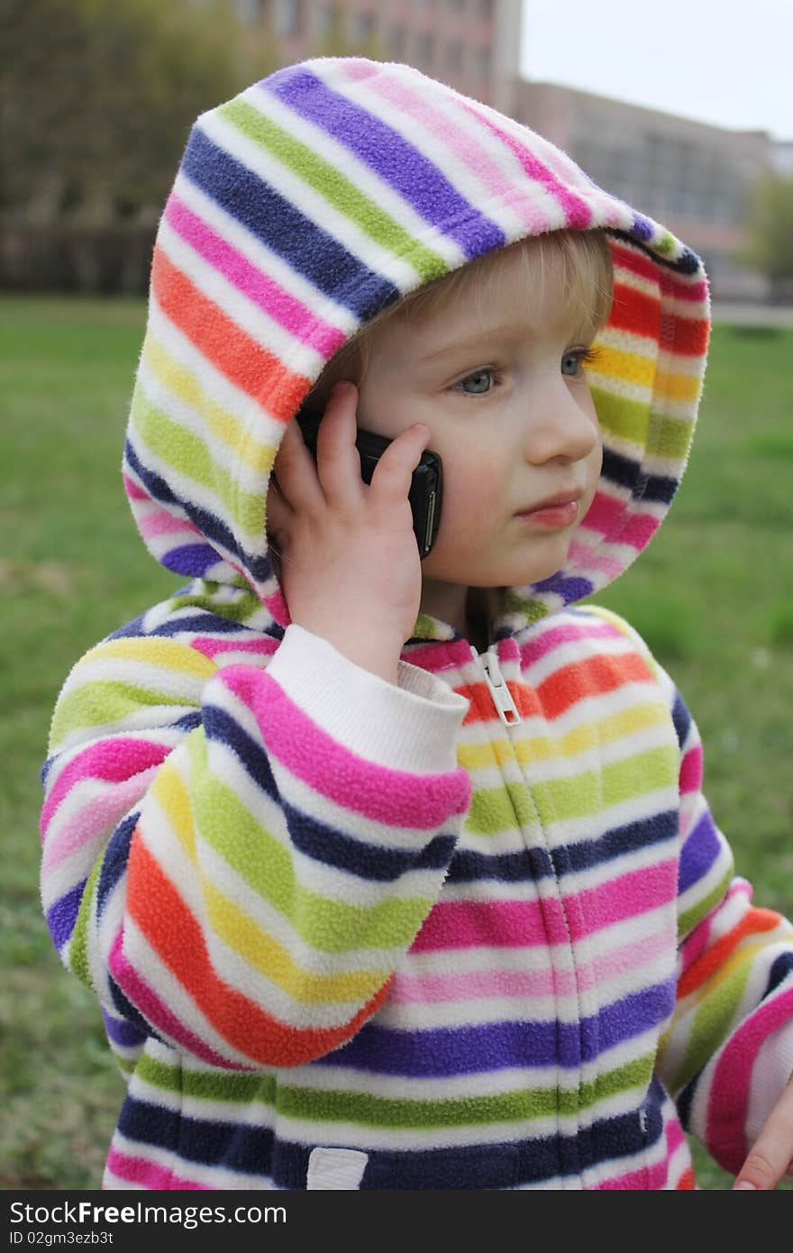 Little girl talking on the phone for a walk
