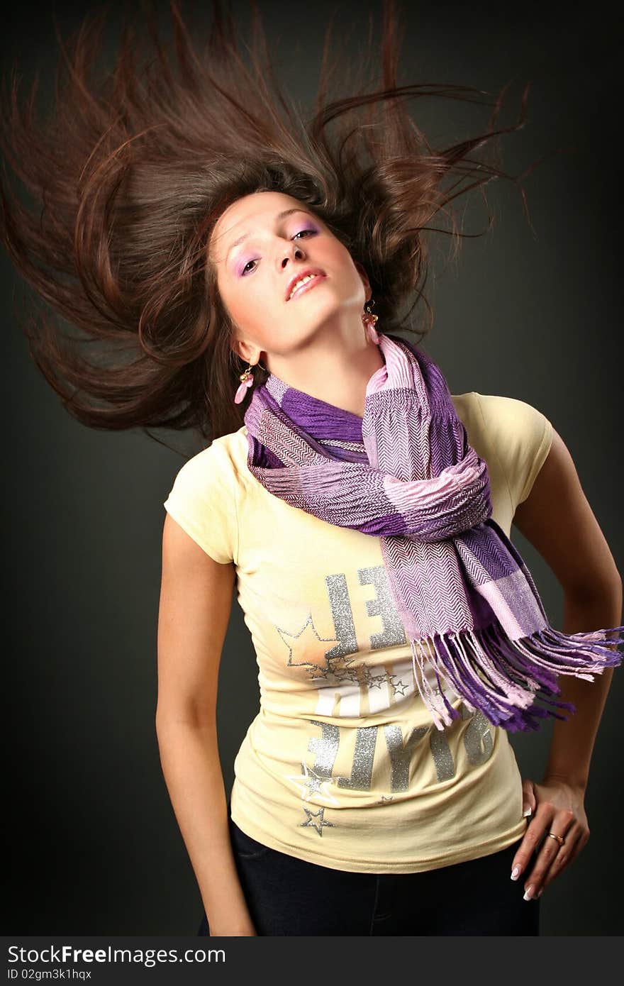 Beautiful young woman dancing in dark