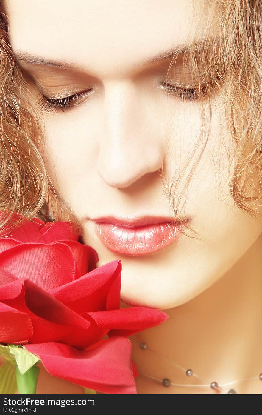 Woman face with rose close-up