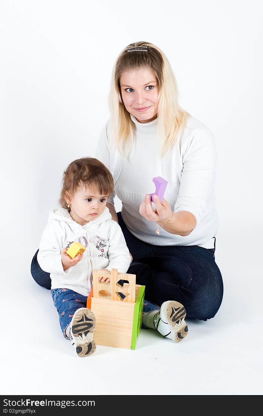 Mother and  daughter playing with puzzle cube