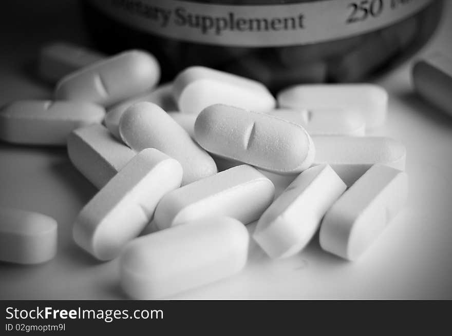 Close up picture of vitamin pills on white background