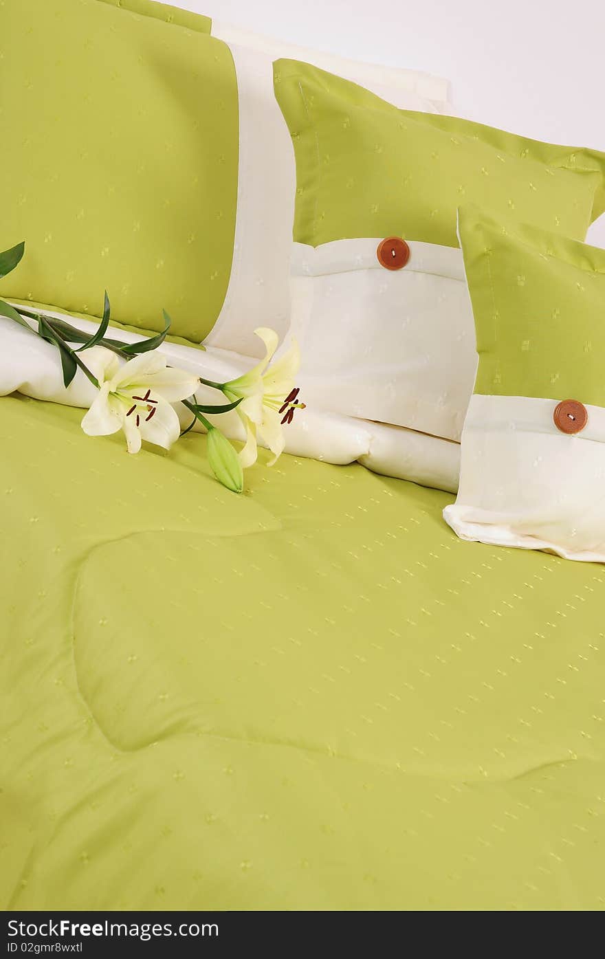 Green bed with three pillows. Green bed with three pillows.