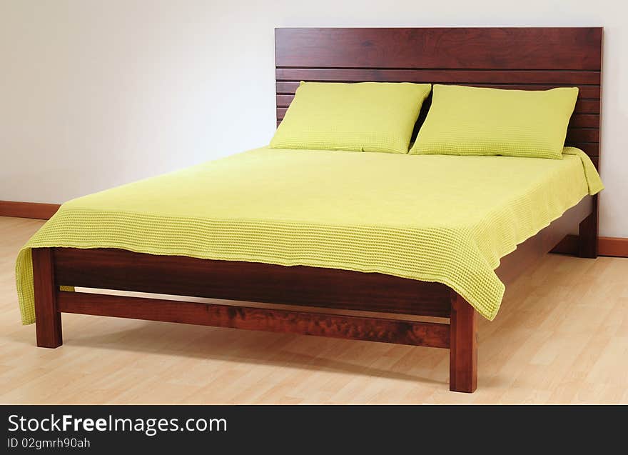 Brown bed with green spreads. Brown bed with green spreads.