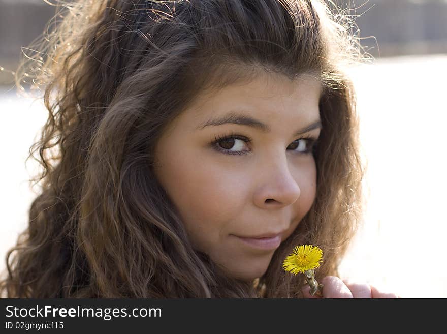 Girl s face with yellow flower