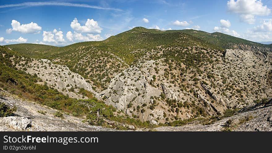 Crimea mountains with pine trees and juniper under blue sky. Crimea mountains with pine trees and juniper under blue sky