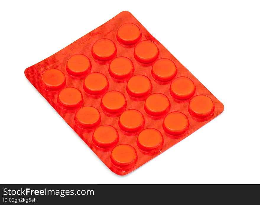 White round pills on the white isolated background