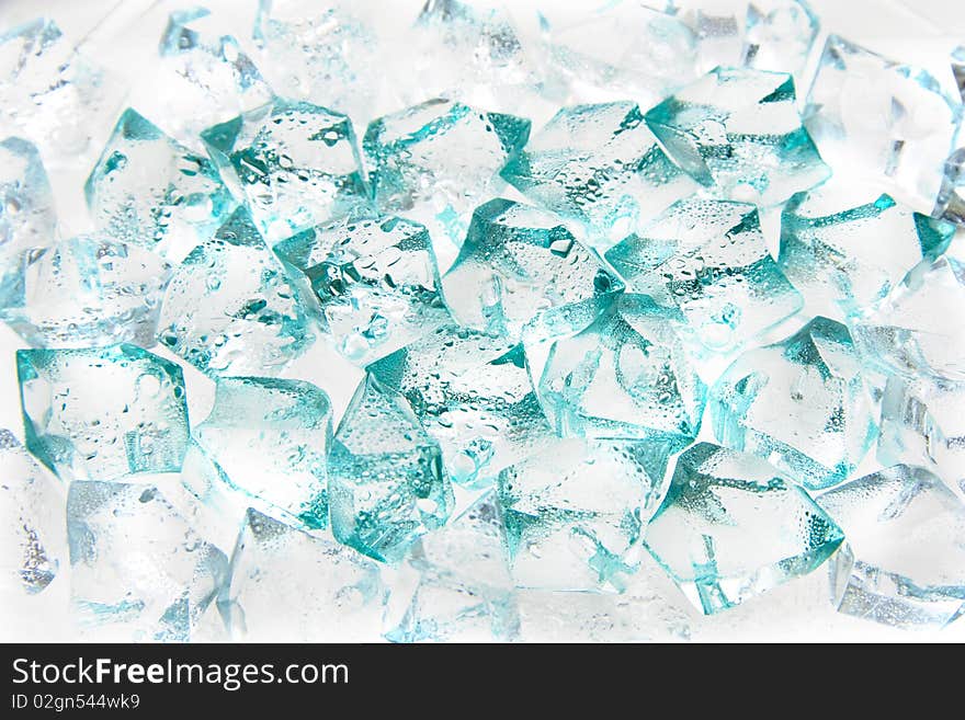 Wet pieces of glass of the different size with a turquoise shade