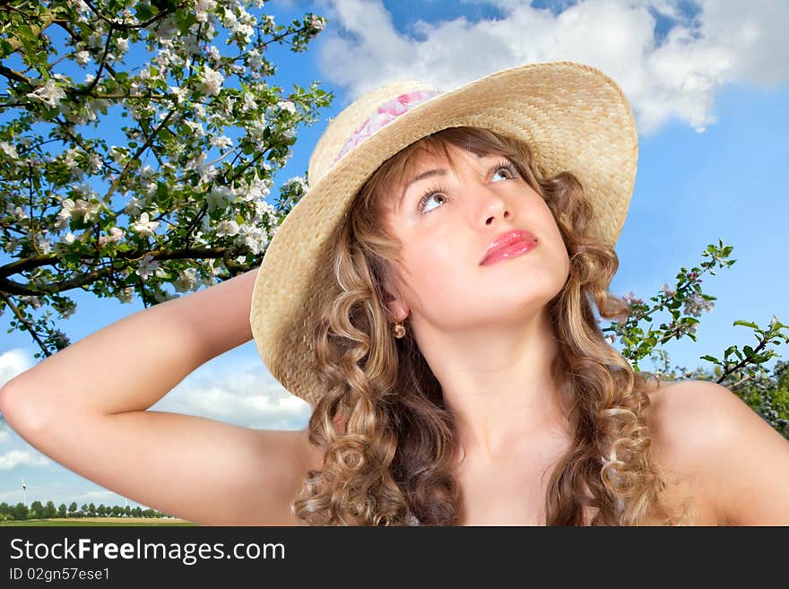 Closeup portrait of a cute young woman wearing a straw hat