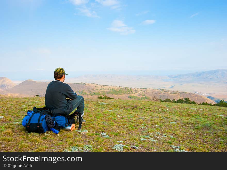 Hiker Sits On The Slope