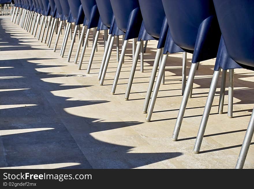 Row of blue chairs from behind in a holiday resort, Turkey. Row of blue chairs from behind in a holiday resort, Turkey