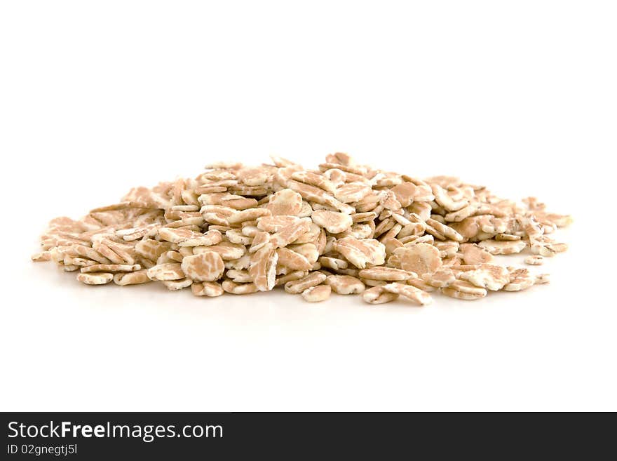 Organic wheat flakes isolated on white background.