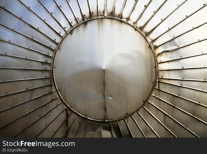 Closeup on a tip of a large factory metal cylinder. Closeup on a tip of a large factory metal cylinder