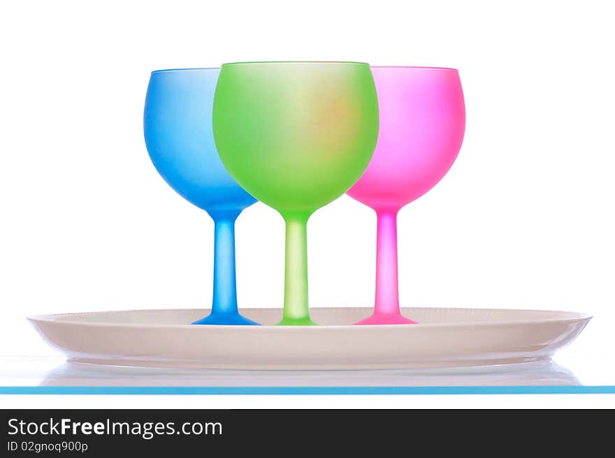 Three colored glasses for cocktails on the plate for party