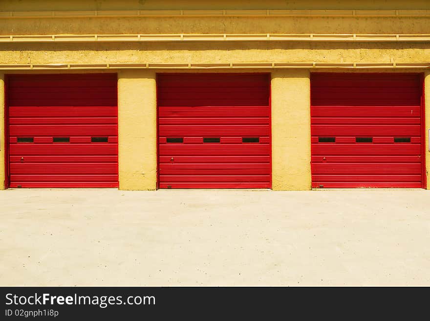 Three Red Doors In A Yellow Building