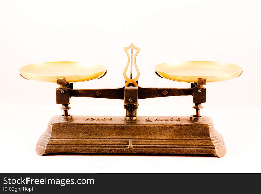 An antique scale on white background, useful for conceptual