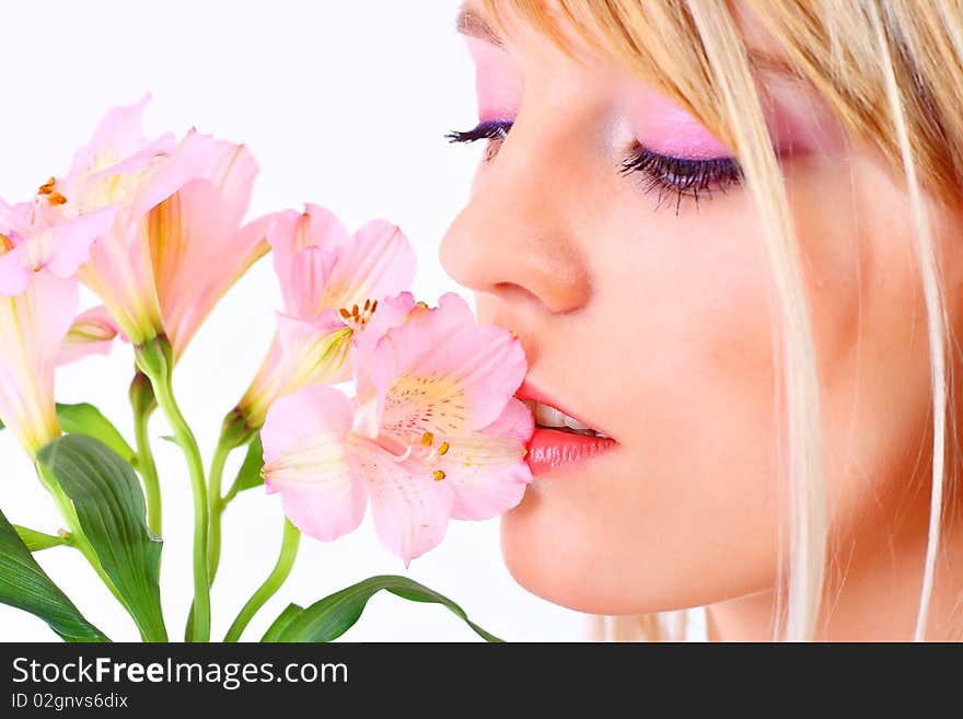 Portrait of a woman holding pink flowers over white background