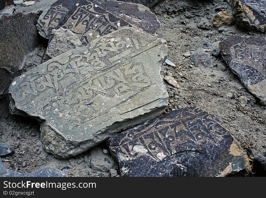 Stones with buddhist mantras and signs.