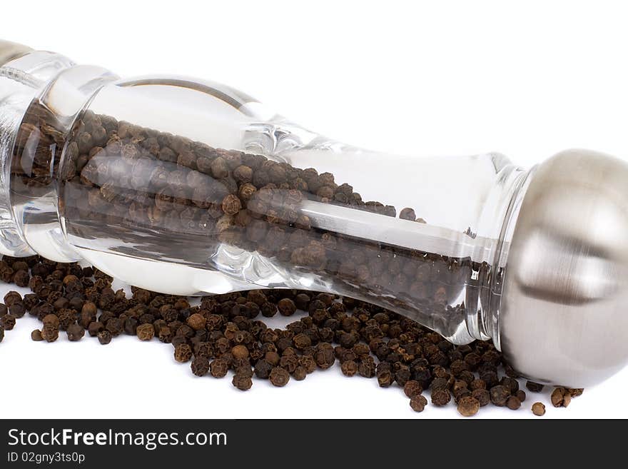 A series. A glass grinder of pepper isolated on a white background